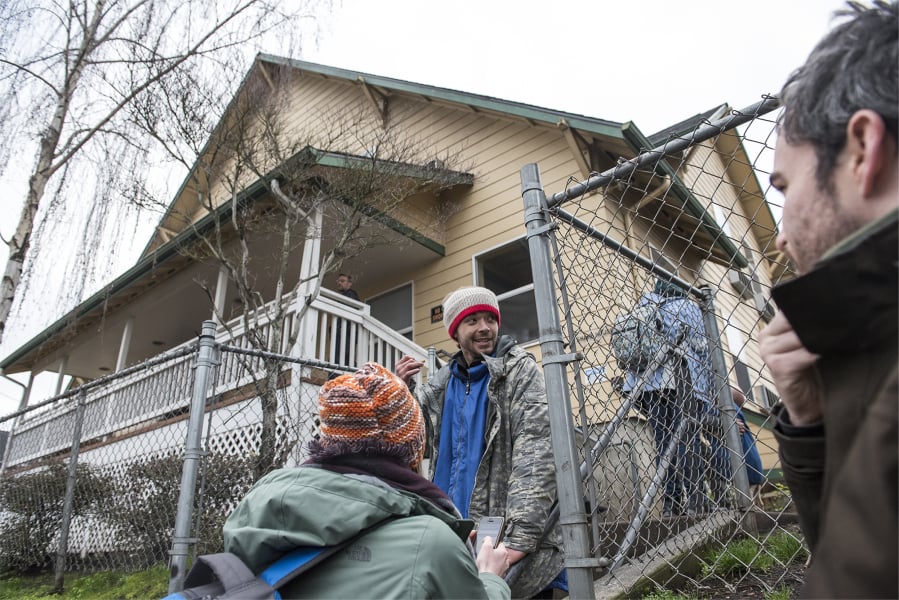 Katelyn Benhoff, lead outreach case manager with Share, left, speaks with Dimitri Coles in front of Share House while performing the annual Point in Time Count on Jan. 24, 2019.