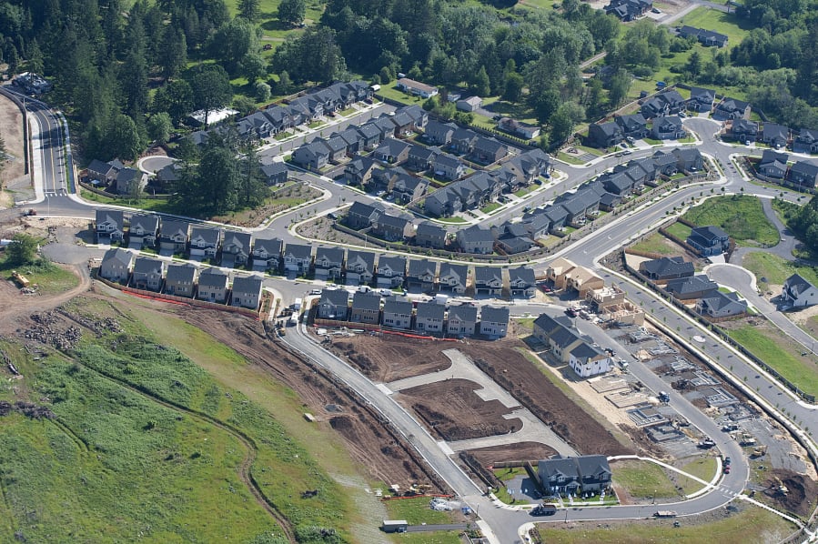 New homes under construction are seen near Woodburn Elementary School in 2016.