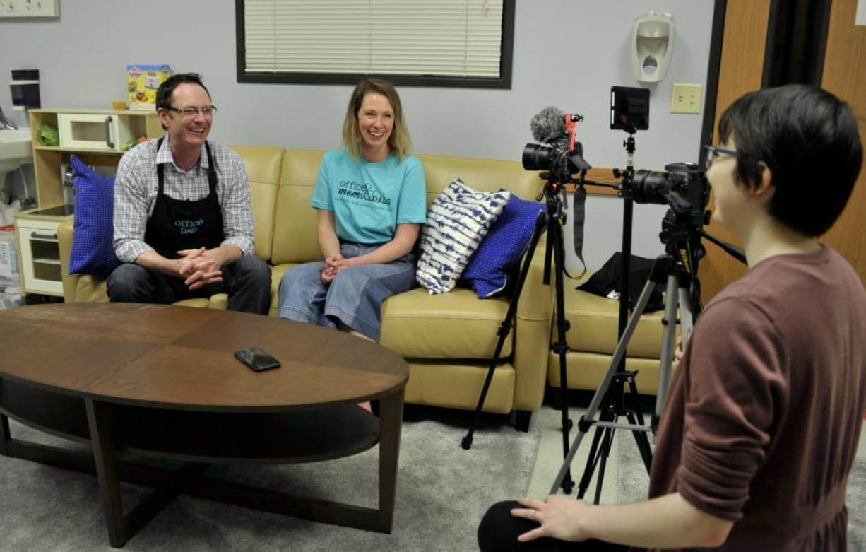 From left, Bill Love and Sarah Desjarlais rehearse with videographer Madeleine Philbrook for a promotional video in Office Moms & Dads’ space in the child welfare office in downtown Vancouver.