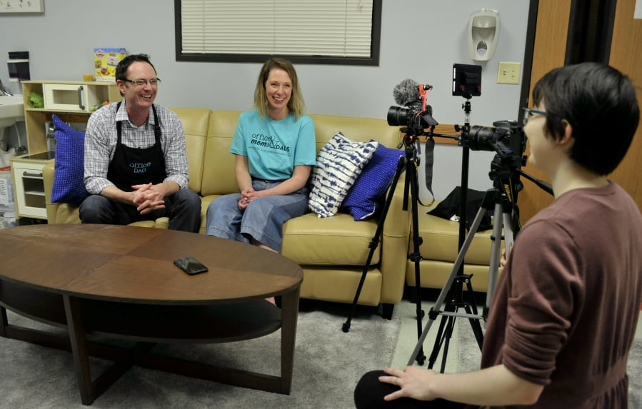 From left, Bill Love and Sarah Desjarlais rehearse with videographer Madeleine Philbrook for a promotional video in Office Moms & Dads’ space in the child welfare office in downtown Vancouver.