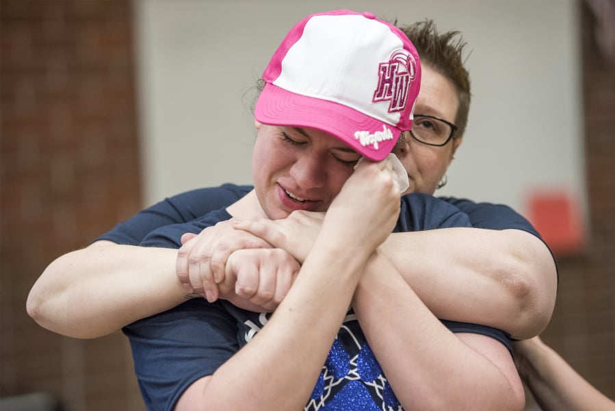Lauren Reagan, front, is comforted by Copper Long, a family friend, while the jersey of her late son Declan Reagan is presented prior to a Harlem Wizards game at Union High School. The ceremony honored Declan, know as Declan the Dinosaur, who was an honorary draft pick of the Wizards last year. Declan died in May 2018 at age 6 after fighting multiple cancers.