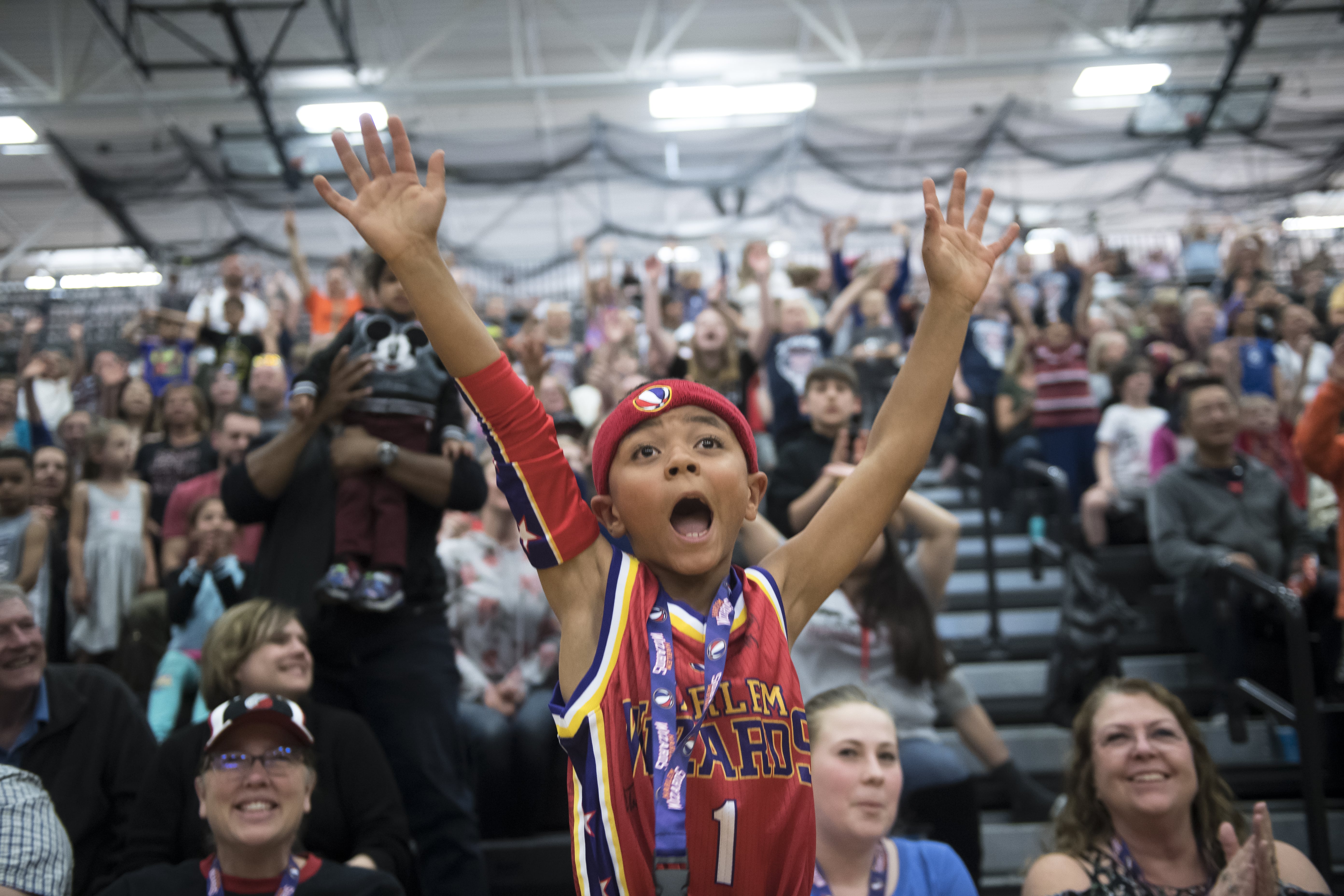 Kaden Butler, 7, cheers for the Harlem Wizards during a game at Union High School on Thursday night, May 2, 2019.