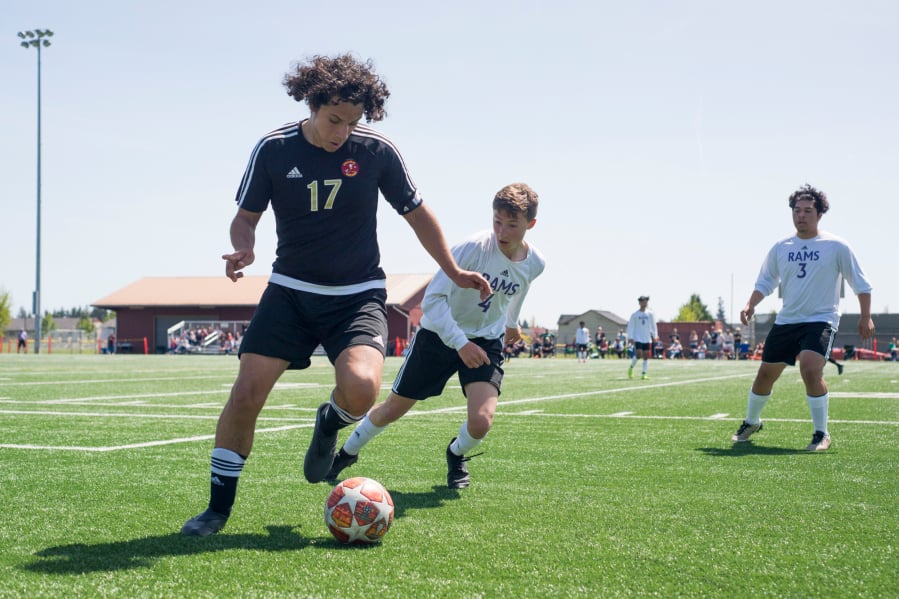 Prairie junior Quentin Roemer dribbles the ball near the sideline during a game against North Thurston at Prairie High School on Saturday, May 4, 2019. Prairie beat North Thurston 3-0 to move on to the next round of the state soccer tournament.