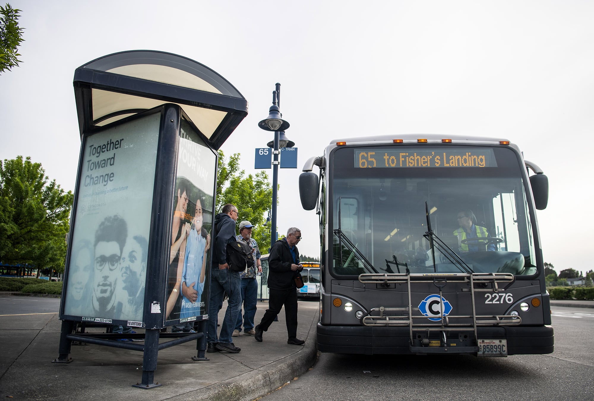 Passengers board the 65 route that travels to Fisher's Landing Transit Center in Vancouver at the Parkrose/ Sumner Transit Center in Portland, Ore., on Monday evening, May 13, 2019.