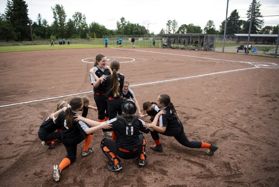 The East County Warriors circle up for a cheer before their game at George Schmid Memorial Park in Washougal on Tuesday. While the complex sees plenty of action, there is no electricity, running water or lights, but the city received more than $1 million in the state budget to make upgrades at the field. Now, Washougal and East County Little League officials are figuring out how to raise the rest of the funds to build a third field, add lights and get amenities to the complex.