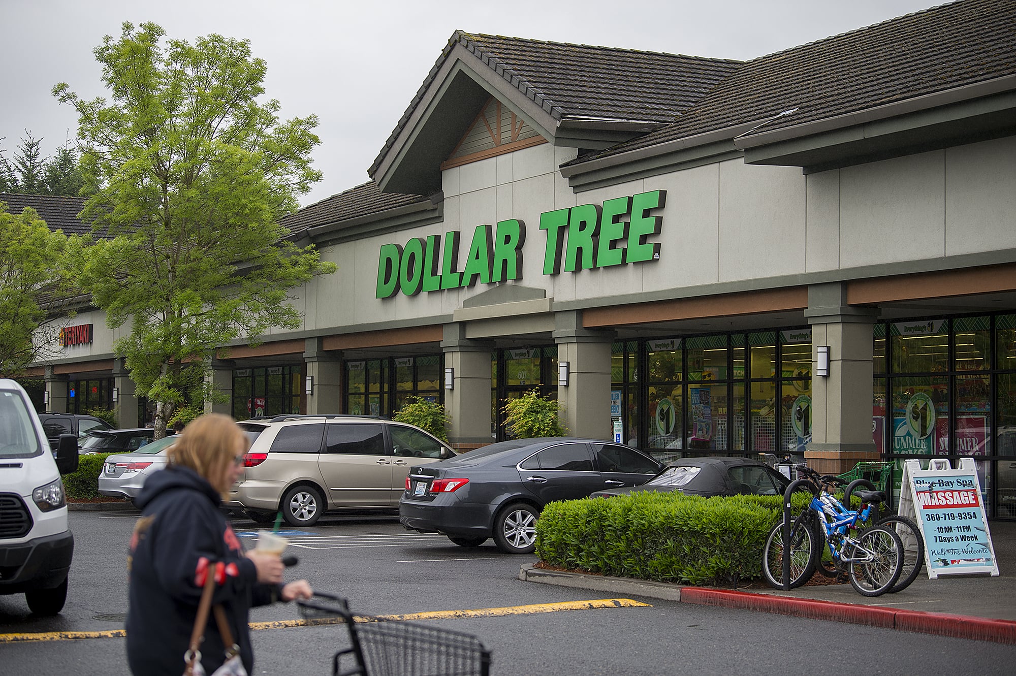 A shopper passes a Dollar Tree along Northeast 162nd Avenue on Thursday afternoon, May 16, 2019. The Washington State Department of Labor &amp; Industries announced Thursday a $503,200 fine against the store, alleging unsafe conditions.