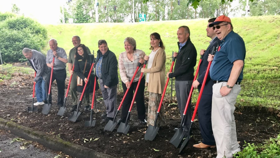Elected officials and other dignitaries take part in a groundbreaking ceremony for two roundabouts that will be built on state Highway 14 in Washougal.