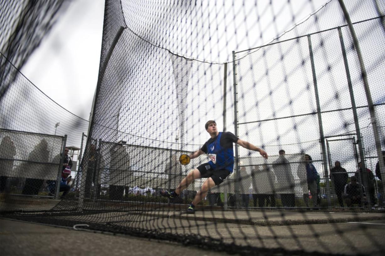Ridgefield’s Trey Knight completes a throw to win the state title during the 2A Boys Discus Throw.