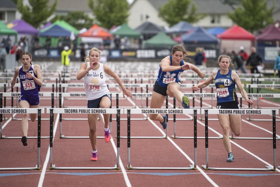 Mountain View’s Kate Kadrmas, center right, leads the pack to win the 3A Girls 100m Hurdles during the WIAA state track meet at Mount Tahoma High School in Tacoma on Friday, May 24, 2019.