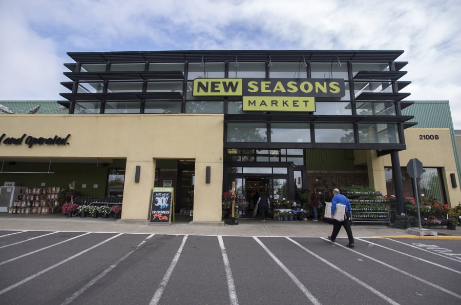 Customers walk into the New Seasons Market in Vancouver.