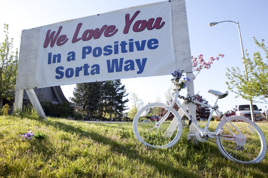 A memorial sign and white “ghost bike” photographed in 2009 alongside St. Johns Road, where cyclist and popular Hudson’s Bay High School teacher Gordon Patterson was killed by a driver who was texting while driving. A commemorative “Ride of Silence,” honoring all cycling casualties, is set for Wednesday.