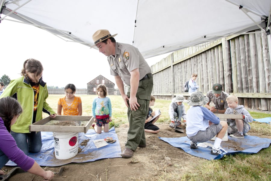 Mike Twist leads a mock archaeology dig that a small group of kids participated in at the Fort Vancouver National Historic Site.