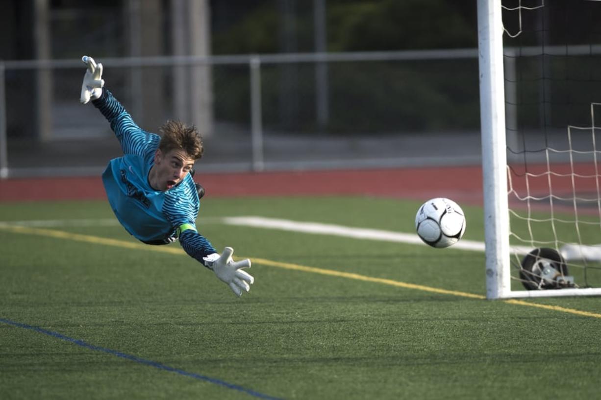 Sehome Goalkeeper Mason Kealy dives for and misses a shot on goal by Columbia River that would bonce off the goalpost during the WIAA 2A Championship title game at Sumner High School on Saturday afternoon, May 25, 2019 (Nathan Howard/The Columbian)