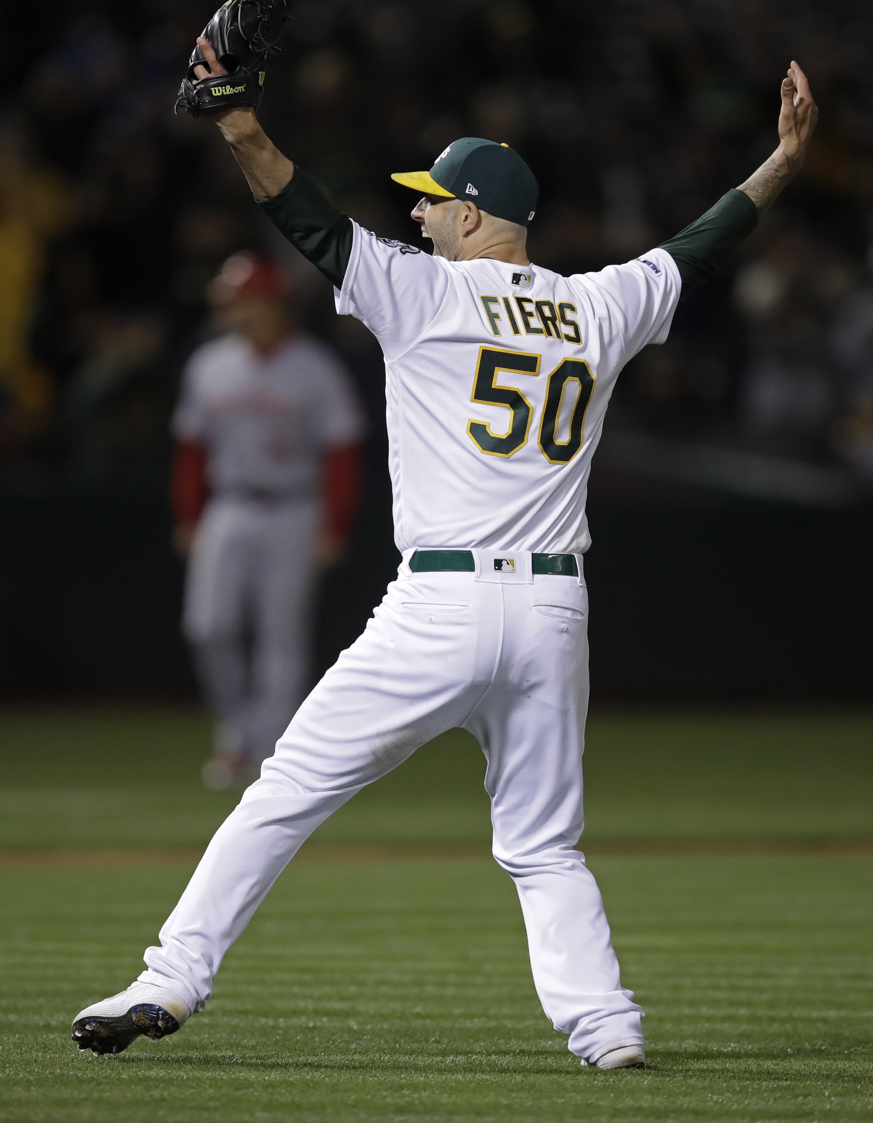 Oakland Athletics' Mike Fiers celebrates after pitching a no hitter against the Cincinnati Reds at the end of a baseball game Tuesday, May 7, 2019, in Oakland, Calif.