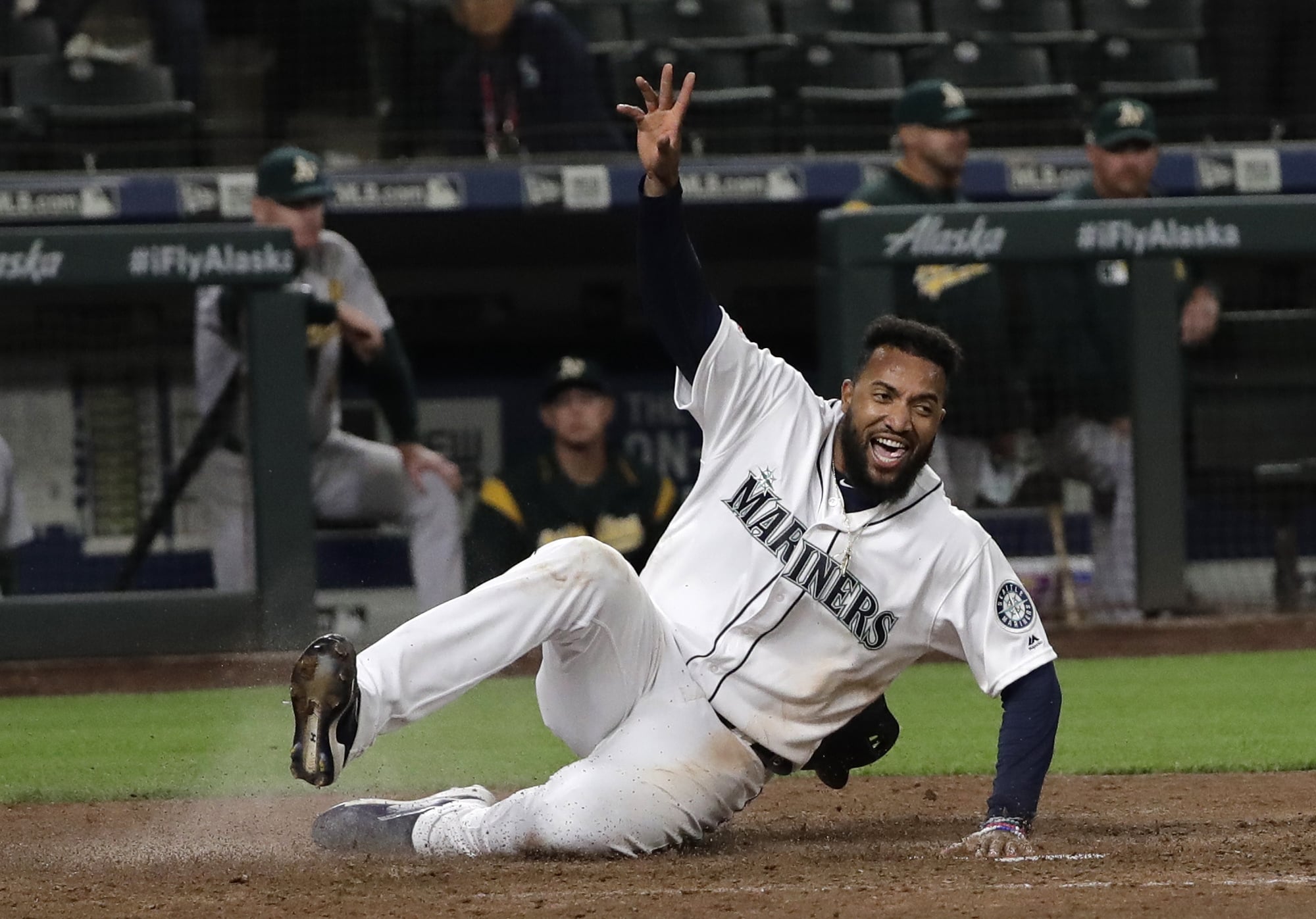 Seattle Mariners' Domingo Santana scores on a walk-off single hit by Omar Narvaez during the 10th inning of a baseball game against the Oakland Athletics, Monday, May 13, 2019, in Seattle. The Mariners won 6-5 in 10 innings. (AP Photo/Ted S.