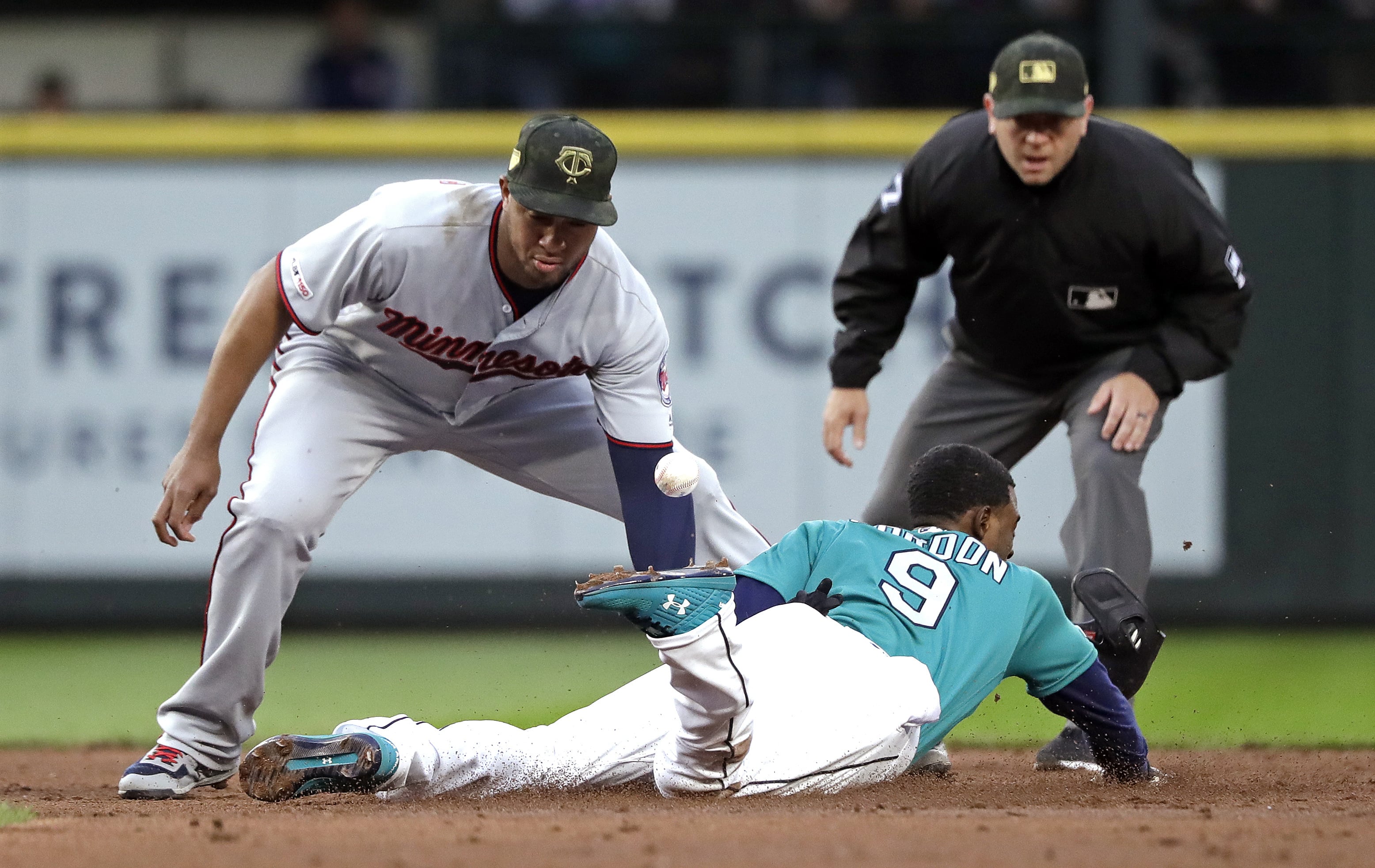 The ball pops away from Minnesota Twins second baseman Jonathan Schoop, left, as Seattle Mariners' Dee Gordon steals second base during the third inning of a baseball game Friday, May 17, 2019, in Seattle.