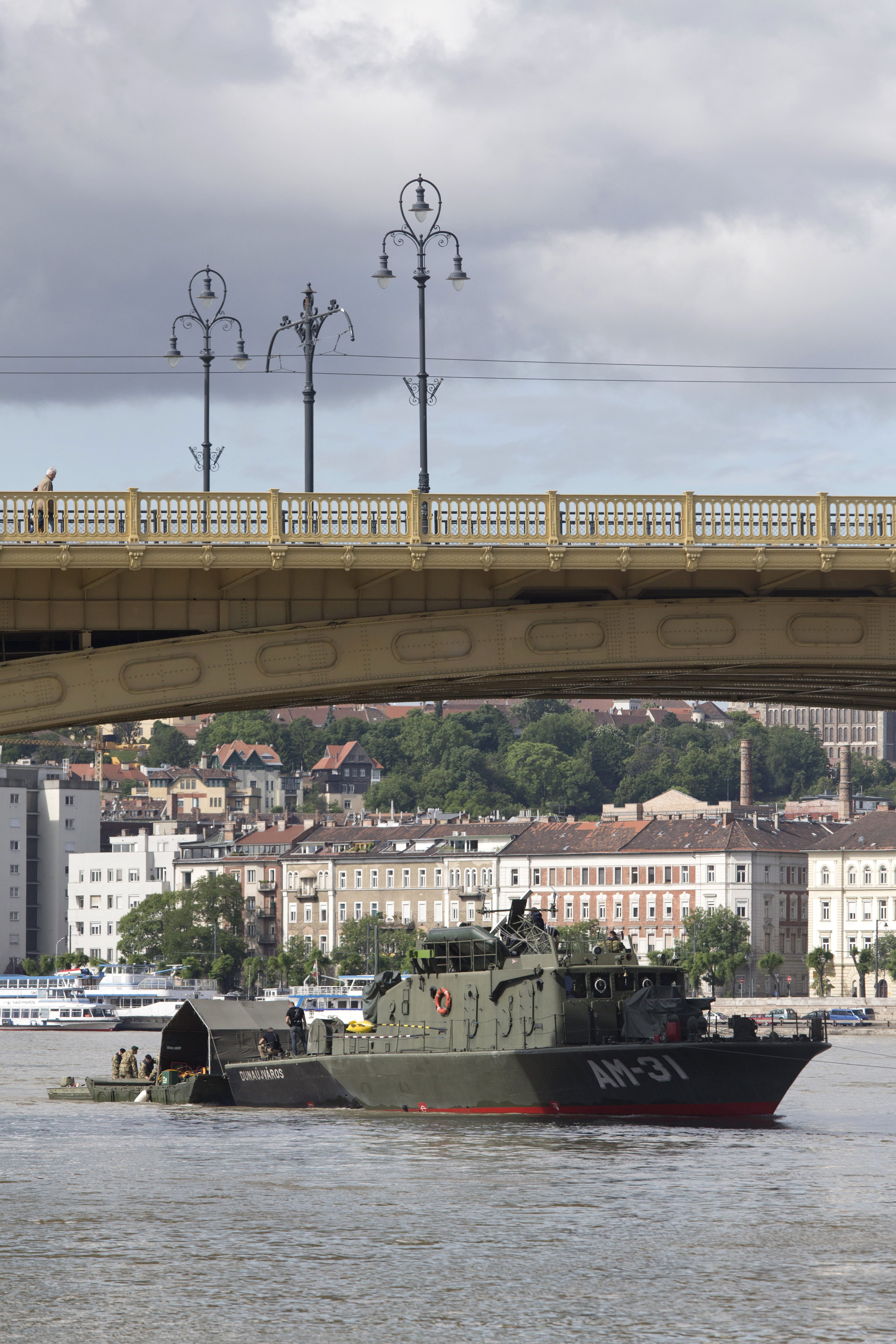 Rescue crew members are seen at work on the Danube River underneath the Margit Bridge where a sightseeing boat capsized in Budapest, Hungary, Friday, May 31, 2019. Hungarian police have detained the captain of a cruise ship that collided with the sightseeing boat packed with South Korean tourists, causing it to sink quickly in the river as loved ones of the missing and dead were expected to arrive Friday in Hungary.