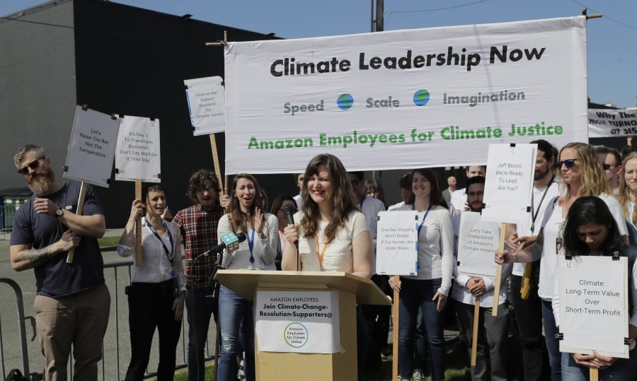 Emily Cunningham, center, who works as a user experience designer at Amazon.com, speaks during a news conference following Amazon’s annual shareholders meeting, Wednesday in Seattle held by the group “Amazon Employees for Climate Justice.” (AP Photo/Ted S.