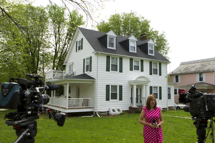TV crews report form outside the house of Baltimore Mayor Catherine Pugh in Baltimore, MD., Thursday, April 25, 2019. Agents with the FBI and IRS are gathering evidence inside the two homes of Pugh and also in City Hall.