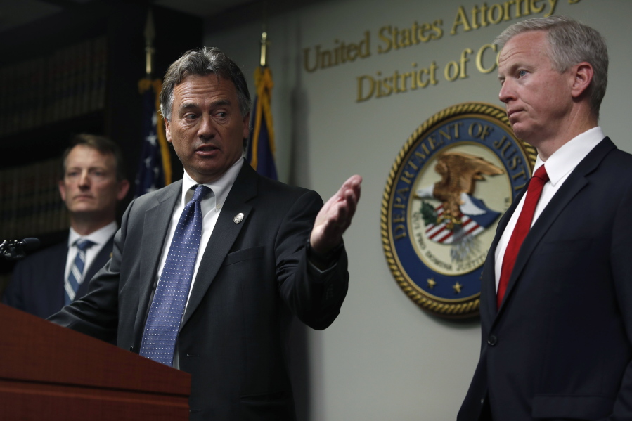 Dave Young, 17th Judicial District Attorney, center, makes a point while U.S. Attorney Jason Dunn, left, and George Brauchler, 18th Judicial District Attorney, listen during a news conference to announce the arrest of 42 people this week in one of the largest black market marijuana enforcement actions in the history of Colorado Friday, May 24, 2019, in Denver.