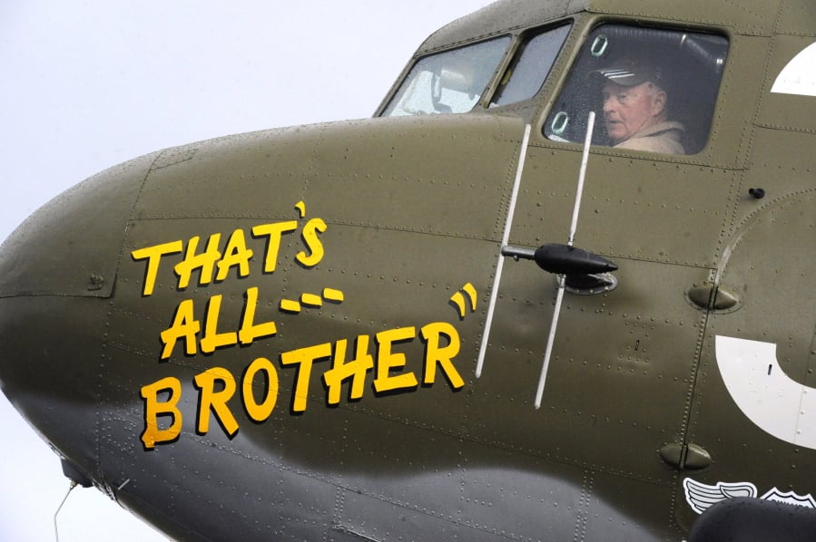 In this April 9, 2019, photo, Pilot Tom Travis sits in the cockpit of the World War II troop carrier That’s All, Brother during a stop in Birmingham, Ala. The C-47 aircraft, which led the main Allied invasion of Europe on June 6, 1944, is returning to the continent to participate in events marking the 75th anniversary of D-Day in June.