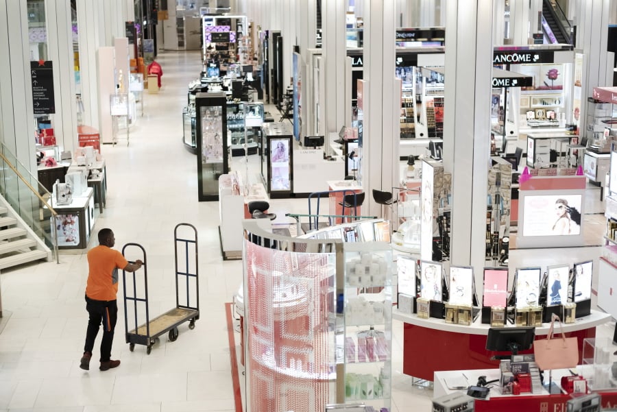 FILE - In this April 10, 2019, file photo a man pushes a stock cart through Macy’s before the store opens to customers in New York. Macy’s Inc. reports financial results Wednesday, May 15.