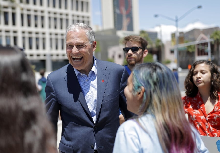 Democratic Presidential candidate Washington Gov. Jay Inslee, center, meets with students at a climate change rally Friday, May 24, 2019, in Las Vegas.