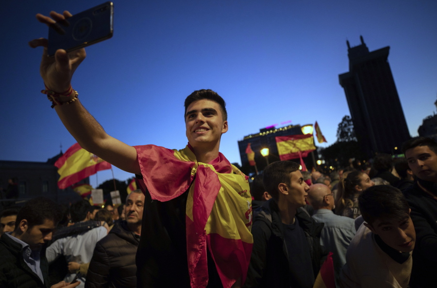 FILE - In this Friday, April 26, 2019 file photo, far-right Vox party supporters attend an election campaign event in Madrid, Spain. In Spain, Vox’s gains have come at the expense of traditional conservatives, who were slow to counter the upstart party’s rise among the young. Its events include the popular “Pints for Spain” evenings at bars, nightclubs and cafes, where no one over 25 is allowed through the door.