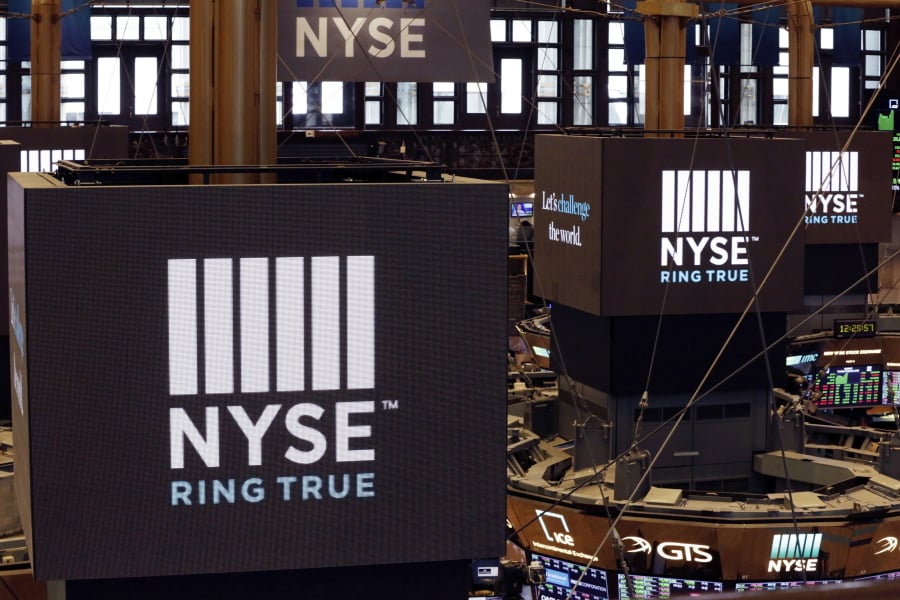 Screens above trading posts on the floor of the New York Stock Exchange show the NYSE logo. U.S. stocks rallied in morning trading on Wall Street Tuesday, May 21, after the U.S. government temporarily eased off its proposed restrictions on technology sales to Chinese companies.