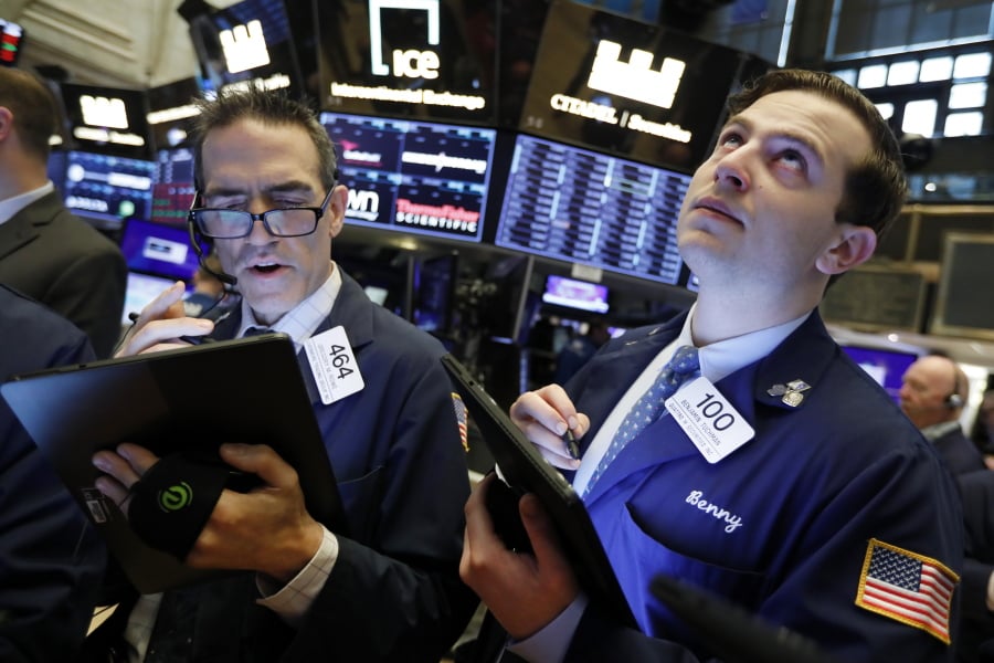 FILE - In this May 9, 2019, file photo traders Gregory Rowe and Benjamin Tuchman work on the floor of the New York Stock Exchange. The U.S. stock market opens at 9:30 a.m. EDT on Friday, May 24.
