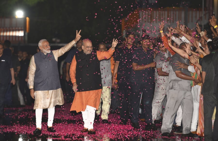 Indian Prime Minister Narendra Modi and Bharatiya Janata Party (BJP) President Amit Shah greet supporters on arrival at the party headquarters in New Delhi, India, Thursday, May 23, 2019. Modi’s Hindu nationalist party claimed it won reelection with a commanding lead in Thursday’s vote count, while the head of the main opposition party conceded a personal defeat that signaled the end of an era for modern India’s main political dynasty.