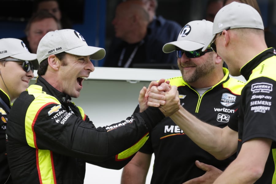 Simon Pagenaud, of France, celebrates with his crew after winning the pole during qualifications for the Indianapolis 500 IndyCar auto race at Indianapolis Motor Speedway, Sunday, May 19, 2019 in Indianapolis.