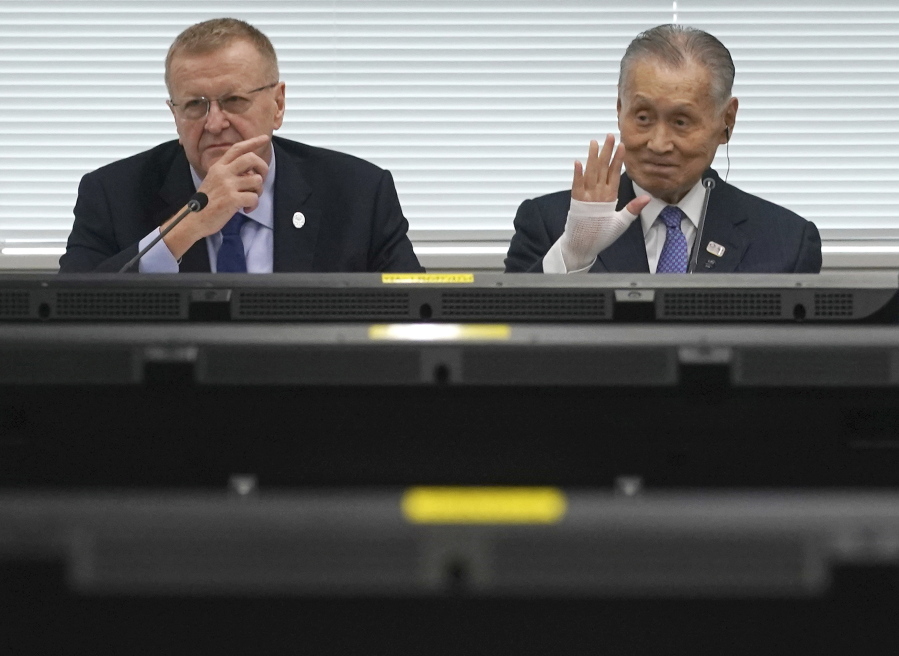 John Coates, left, chairman of the IOC Coordination Commission for the 2020 Tokyo Olympics and Paralympics, Tokyo Olympic organizing committee President Yoshiro Mori, right, pause prior to the IOC Coordination Commission opening plenary session of the Olympic Games Tokyo 2020 in Tokyo Tuesday, May 21, 2019.