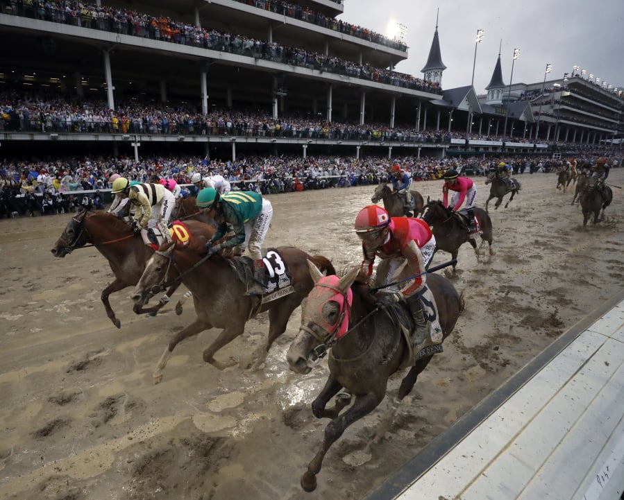 Flavien Prat ride Country House, left, to the finish line during the 145th running of the Kentucky Derby horse race at Churchill Downs Saturday, May 4, 2019, in Louisville, Ky. Country House was declared the winner after Maximum Security was disqualified following a review by race stewards.