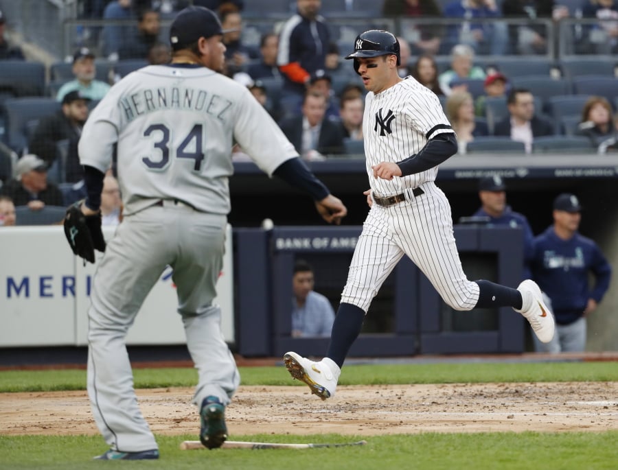 New York Yankees’ Mike Tauchman scores on DJ LeMahieu’s second-inning single as Seattle Mariners starting pitcher Felix Hernandez (34) heads toward the plate during a baseball game, Monday, May 6, 2019, in New York.