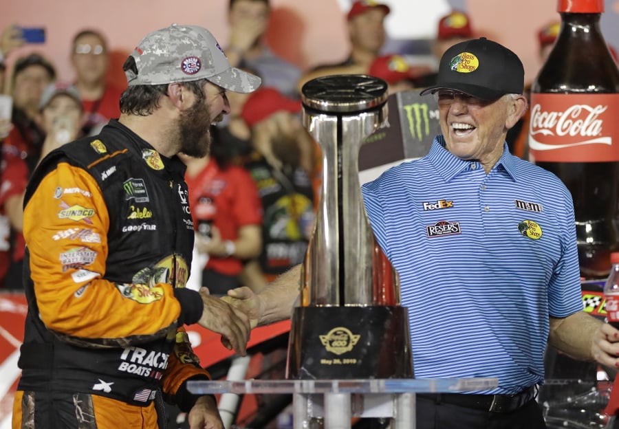 Martin Truex Jr., left, is congratulated by team owner Joe Gibbs in Victory Lane after winning the NASCAR Cup Series auto race at Charlotte Motor Speedway in Concord, N.C., Sunday, May 26, 2019.