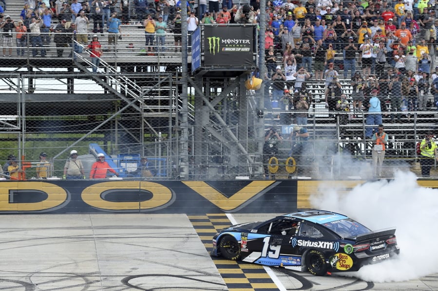 Driver Martin Truex Jr. (19) performs a burnout after winning the NASCAR Cup Series auto race, Monday, May 6, 2019, at Dover International Speedway in Dover, Del.