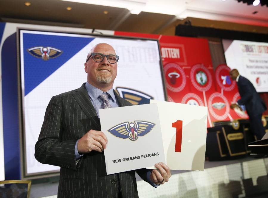 David Griffin, New Orleans Pelicans executive vice president of basketball operations, holds up placards after it was announced that the Pelicans had won the first pick during the NBA basketball draft lottery Tuesday, May 14, 2019, in Chicago.