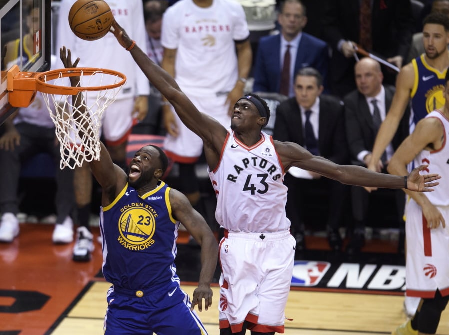 Toronto Raptors forward Pascal Siakam (43) blocks a shot by Golden State Warriors forward Draymond Green (23) during the second half of Game 1 of basketball’s NBA Finals, Thursday, May 30, 2019, in Toronto.