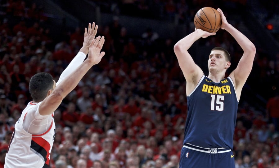 Denver Nuggets center Nikola Jokic, right, looks to shoot over Portland Trail Blazers center Enes Kanter during the first half of Game 4 of an NBA basketball second-round playoff series Sunday, May 5, 2019, in Portland, Ore.