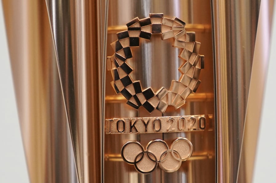FILE - This March 20, 2019, file photo shows the emblem of the Olympic torch of the Tokyo 2020 Olympic Games during a press conference in Tokyo. Tokyo organizers said Wednesday, May 8, 2019, they are trying to cut spending, under pressure from the International Olympic Committee, which has been widely criticized for driving Olympic cities to build “white elephant” venues, often at the taxpayers expense.