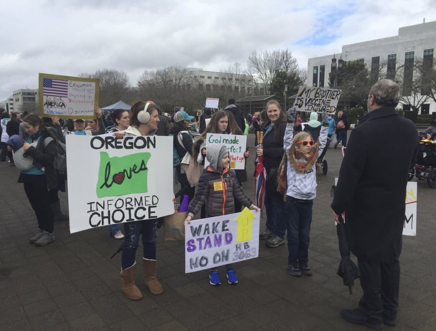 Hundreds attend a rally on March 7 at the Oregon State Capitol in Salem, Ore., protesting a proposal to tighten school vaccine requirements.