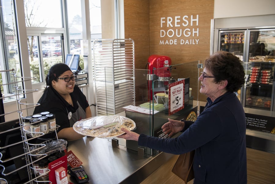 Papa Murphy’s store manager Gladys Marron helps Jo Olson of Vancouver on March 15 at Papa Murphy’s on Southeast Mill Plain Boulevard.
