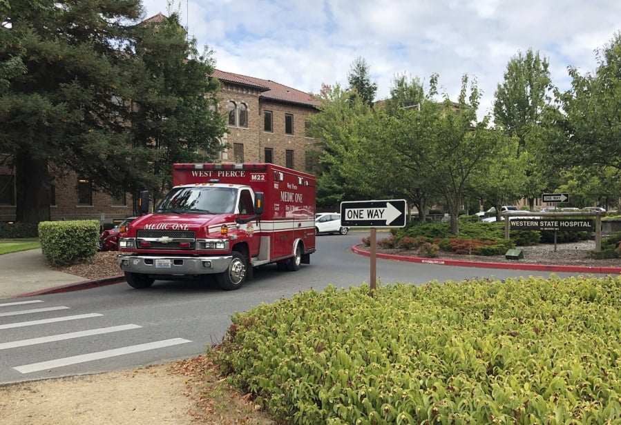 An ambulance leaves Western State Hospital on Aug. 30, 2019, in Lakewood. It is the state’s largest psychiatric hospital.
