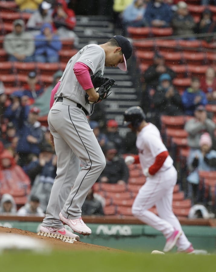 Seattle Mariners’ Marco Gonzales, left, steps on the mound as Boston Red Sox’s J.D. Martinez, right, runs the bases toward home after hitting a home run off a pitch from him in the first inning of a baseball game at Fenway Park, Sunday, May 12, 2019, in Boston.