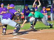Columbia River catcher Xavier Ulrich receivers the throw from left fielder Cole Delich to tag out Tumwater's Damon Gaither in a 2A district semifinal baseball game Wednesday at Ed Wheeler Field in Centralia. Columbia River won 10-4.