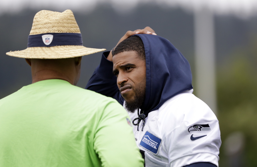 Seattle Seahawks’ Bobby Wagner, right, talks with defensive coordinator Ken Norton Jr. during an NFL football practice Tuesday, May 21, 2019, in Renton, Wash.