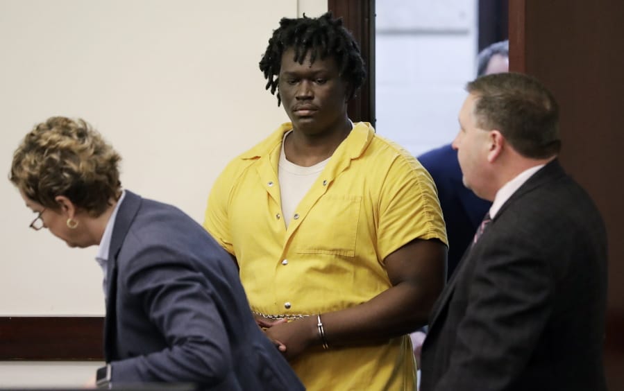 FILE - In this Feb. 20, 2019, file photo, Emanuel Kidega Samson, center, enters the courtroom for a hearing in Nashville, Tenn. Prosecutors have said they’re seeking life without parole for 27-year-old Samson, accused of fatally shooting a woman and wounding several people at a Nashville church. His trial is slated to begin Monday, May 20.