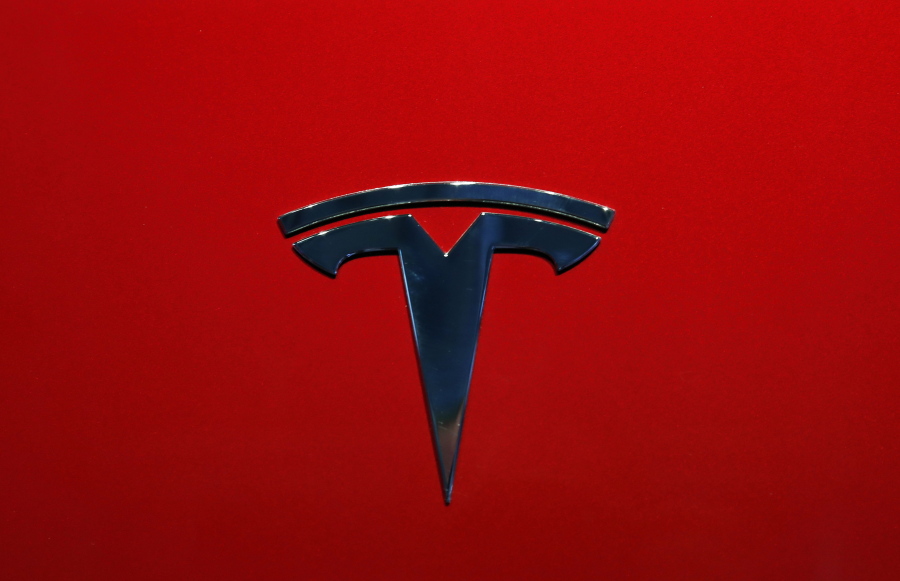 FILE- This Oct. 3, 2018, file photo shows the logo of Tesla model 3 at the Auto show in Paris. The National Transportation Safety Board says Tesla’s Autopilot semi-autonomous driving system was in use when one of its cars drove beneath a semitrailer in Florida in March, killing the driver.