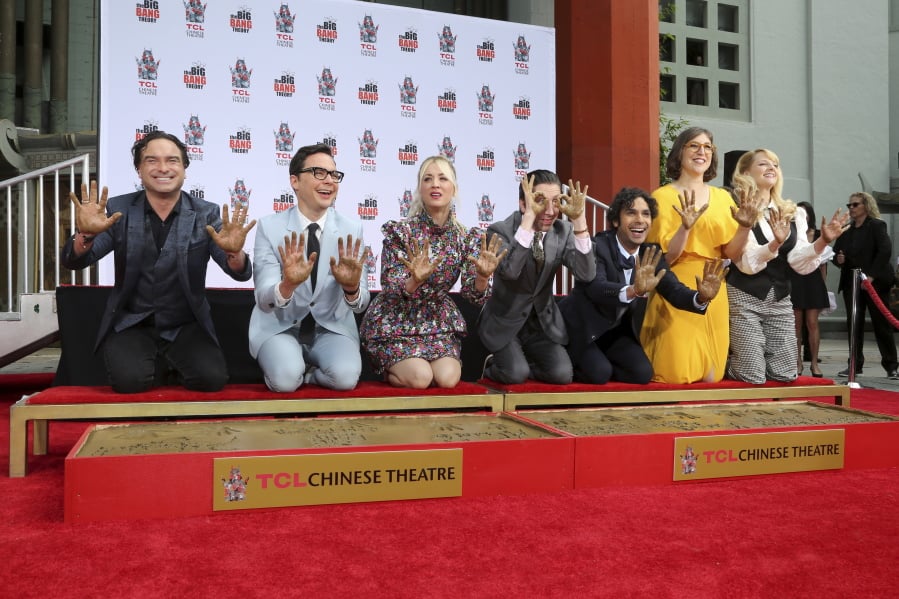 Johnny Galecki, from left, Jim Parsons, Kaley Cuoco, Simon Helberg, Kunal Nayyar, Mayim Bialik and Melissa Rauch members of the cast of the TV series “The Big Bang Theory,” show their hands after placing them in cement during a hand and footprint ceremony at the TCL Chinese Theatre on Wednesday, May 1, 2019 at in Los Angeles.